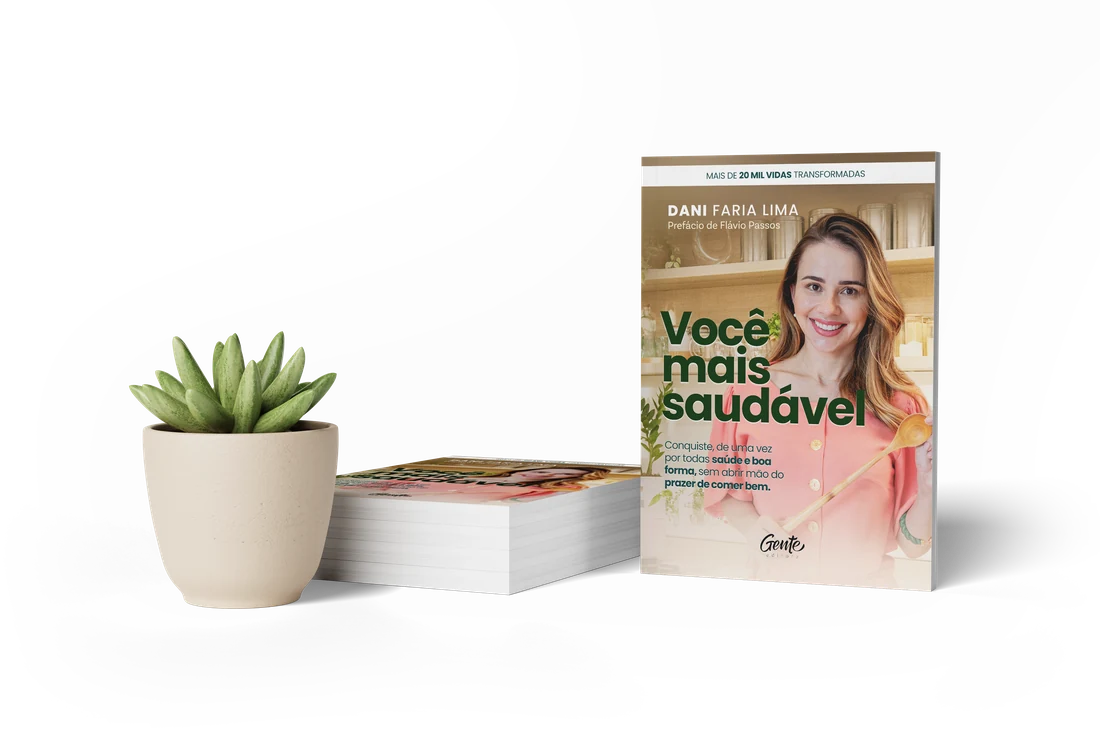 Mockup do livro em cena, ao lado de uma planta
